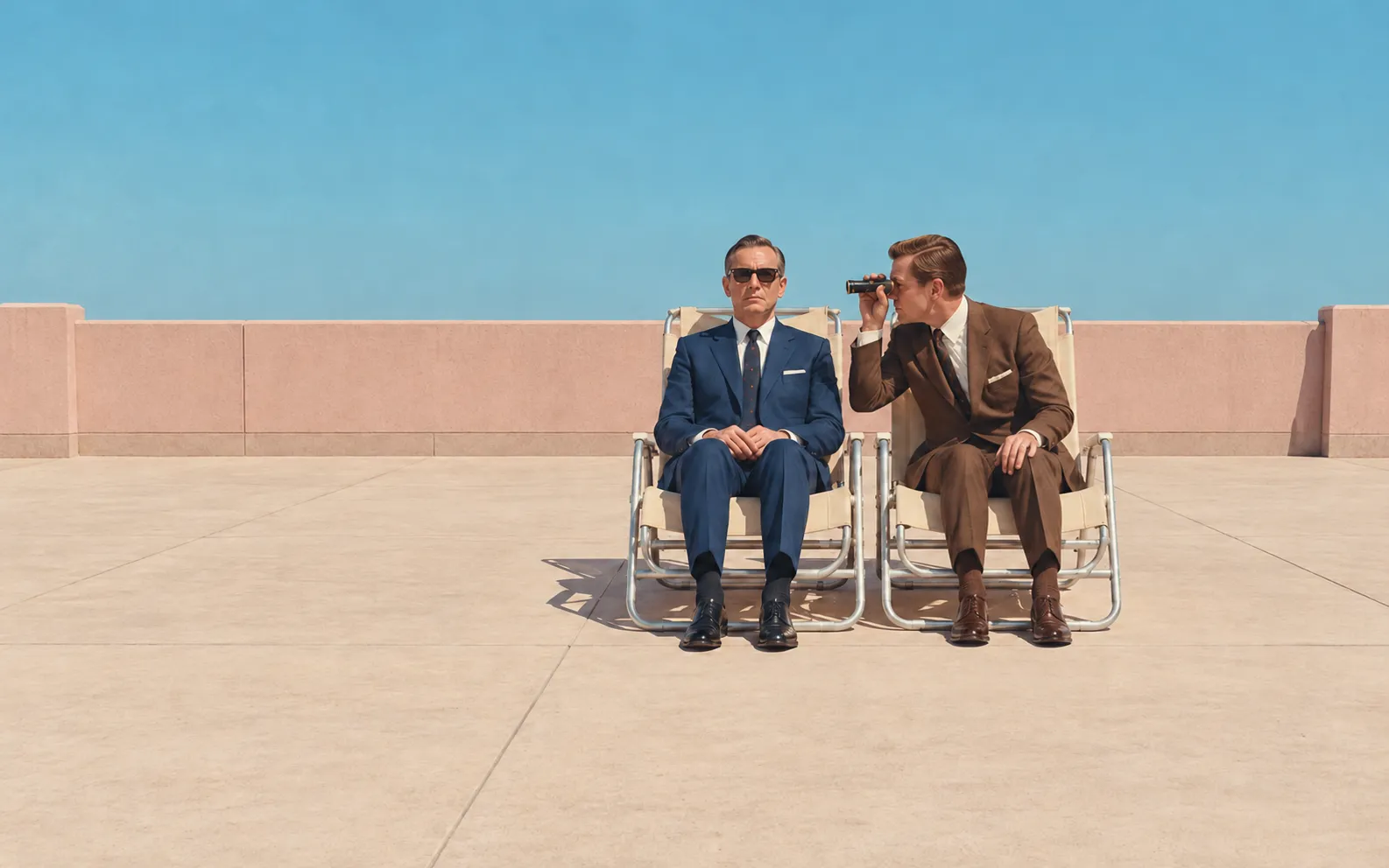 On an empty 1960s rooftop terrace, two suited men sit in aluminium loungers almost touching. One peers at his neighbour through opera glasses while the other stares straight ahead behind sunglasses.
